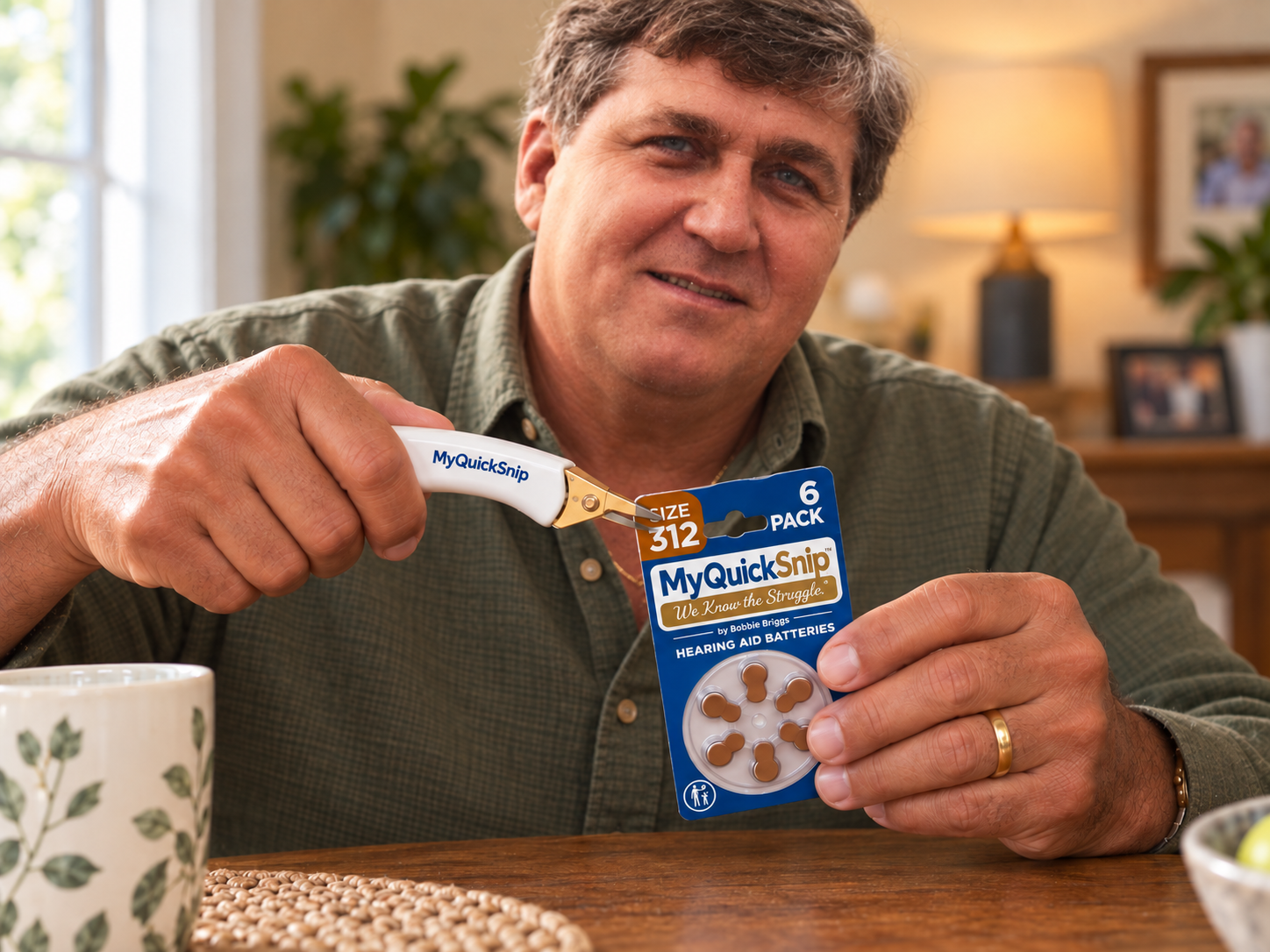 Senior hands using MyQuickSnip to open a hearing aid battery package